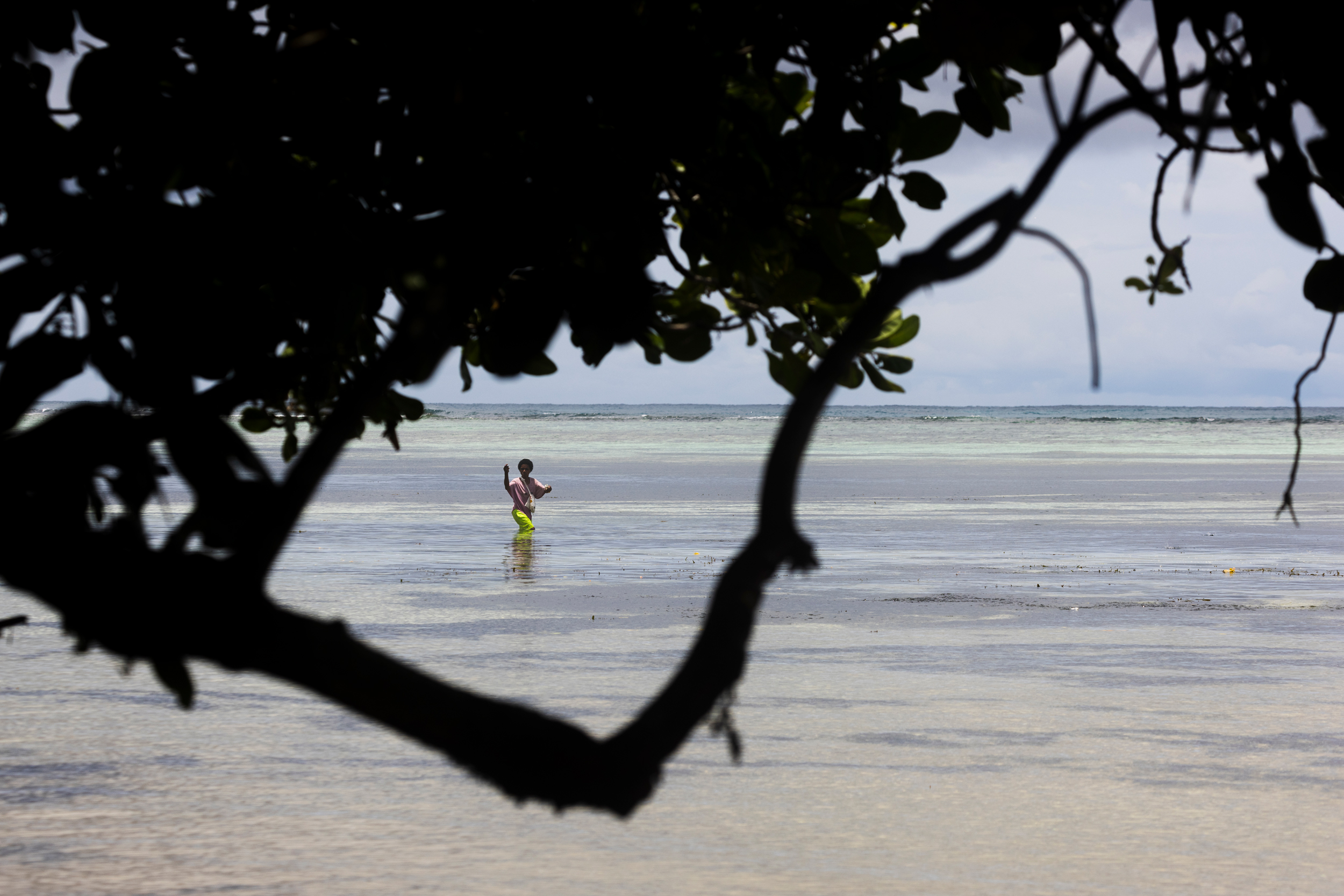 Local authorities have urged people to stop fishing to avoid getting sick from the toxic event. But, out of necessity, some people are still entering the water. Credit: Sebastian Velasquez