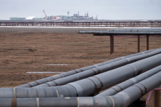 Oil pipelines stretch across the landscape outside Nuiqsut, Alaska, where ConocoPhillips operates the Alpine Field. Credit: Bonnie Jo Mount/The Washington Post via Getty Images