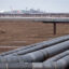 Oil pipelines stretch across the landscape outside Nuiqsut, Alaska, where ConocoPhillips operates the Alpine Field. Credit: Bonnie Jo Mount/The Washington Post via Getty Images