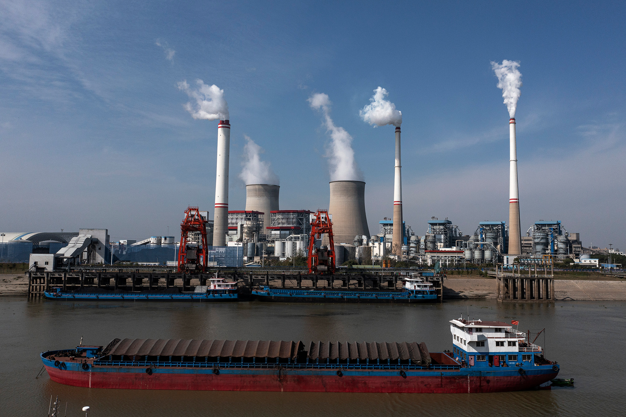 Ships carry coal transport to unload outside a coal-fired power plant in Hanchuan, China. Credit: Getty Images