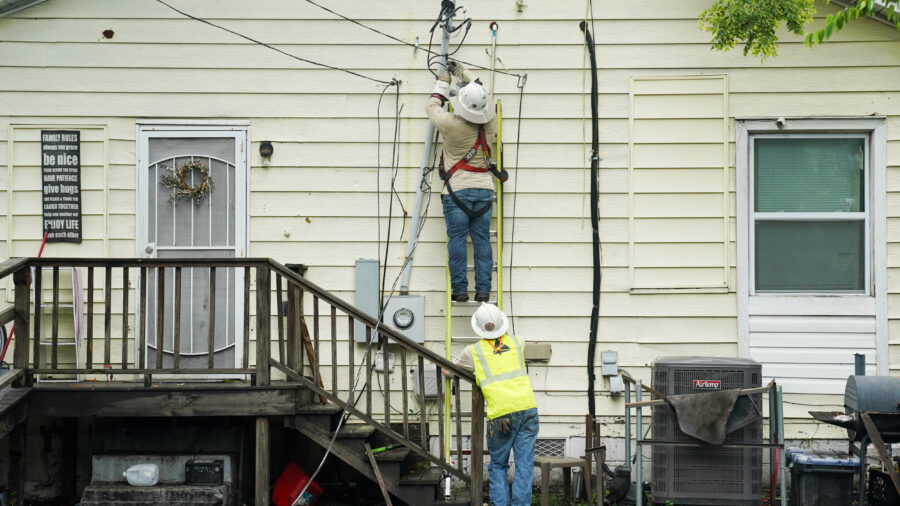 Power line crews with Georgia Power work at a home in Savannah on Aug. 6, 2024. Credit: Megan Varner/Getty Images