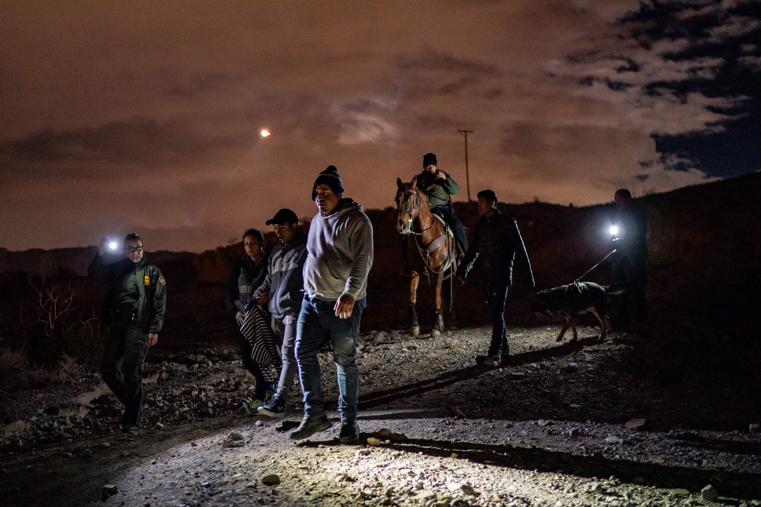 Migrants are apprehended by Border Patrol agents on Mount Cristo Rey in Sunland Park, N.M., on Jan. 18, 2022. Credit: Salwan Georges/The Washington Post via Getty Images