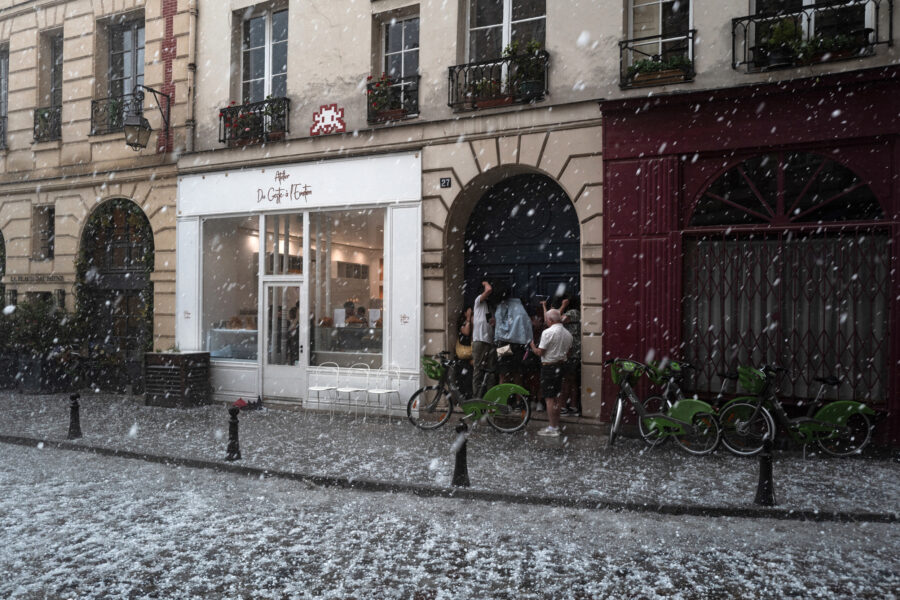 People take cover as a thunderstorm, accompanied by heavy hail, sweeps through Paris on May 3, 2025. Credit: Jerome Gilles/NurPhoto via Getty Images
