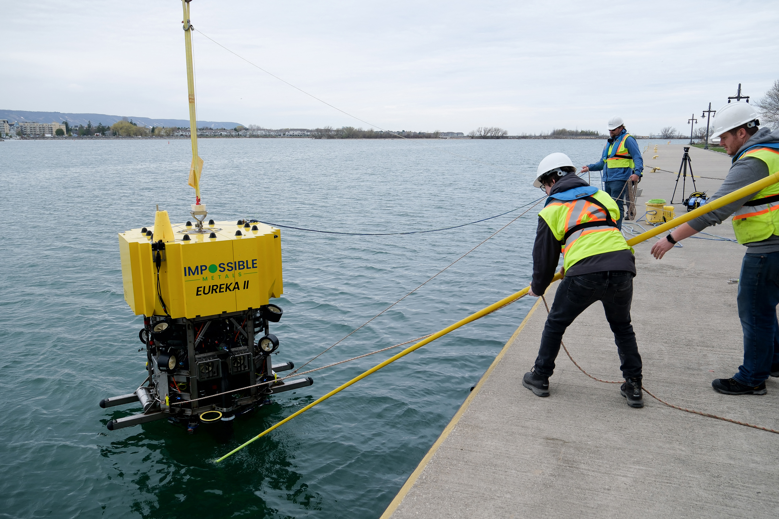 Impossible Metals workers lift the Eureka II, a robotic underwater harvesting vehicle, from a lake in Collingwood, Ontario, on May 1, 2025. Credit: John Wong/AFP via Getty Images