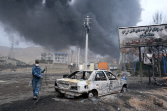 Plumes of smoke rise over the oil depot tanks hit by overnight attacks on March 8 in Tehran, Iran. Credit: Kaveh Kazemi/Getty Images