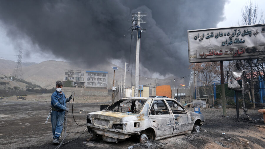 Plumes of smoke rise over the oil depot tanks hit by overnight attacks on March 8 in Tehran, Iran. Credit: Kaveh Kazemi/Getty Images