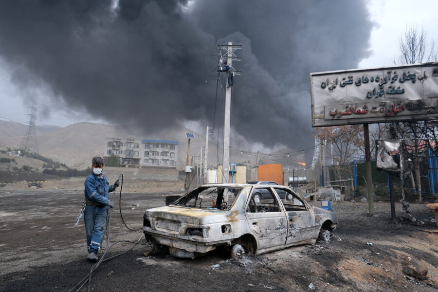 Plumes of smoke rise over the oil depot tanks hit by overnight attacks on March 8 in Tehran, Iran. Credit: Kaveh Kazemi/Getty Images