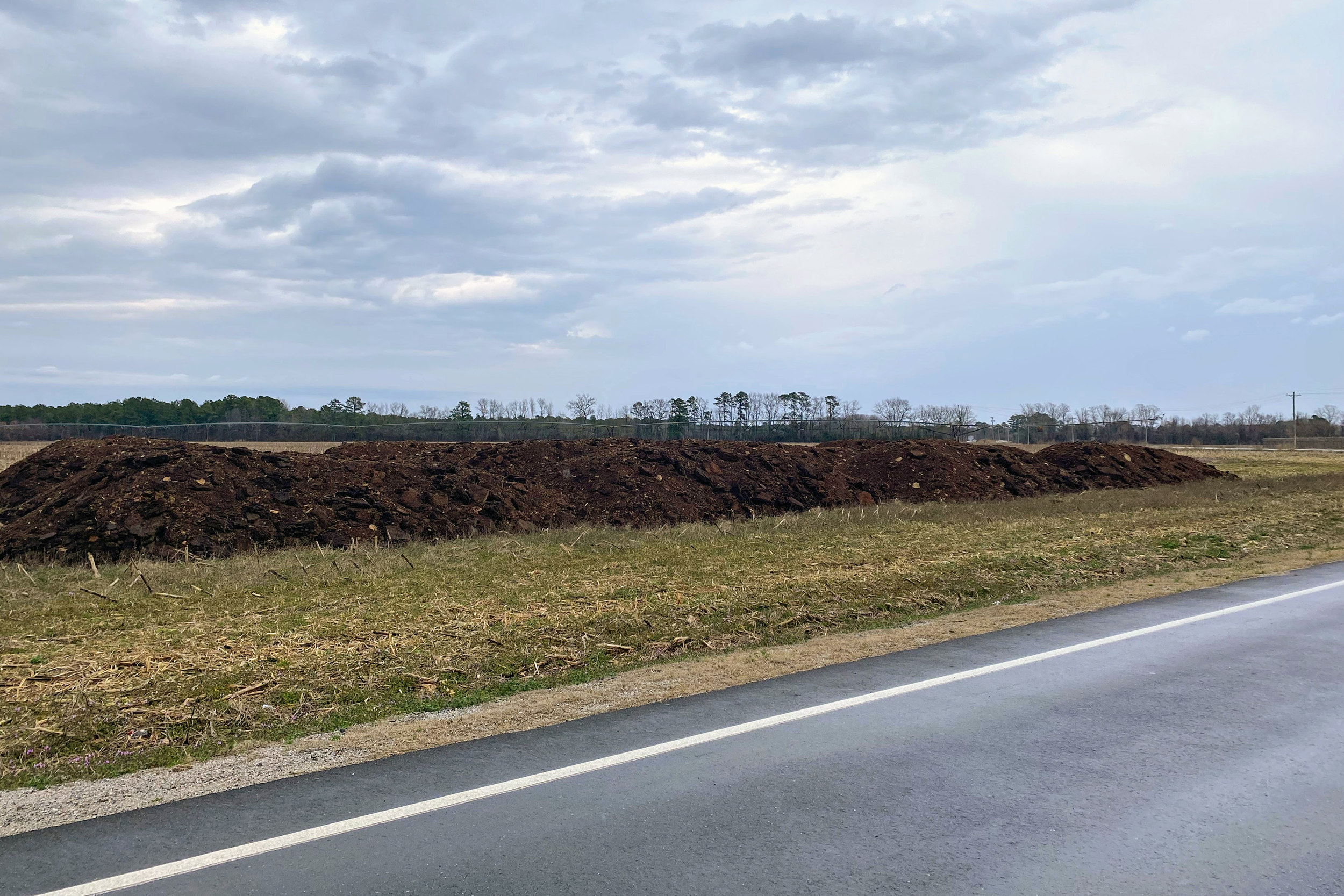A ridge of chicken feces on Gaddy’s Mill Road in southern Robeson County. The waste can legally sit outside for as long as 15 days. Credit: Lisa Sorg/Inside Climate News
