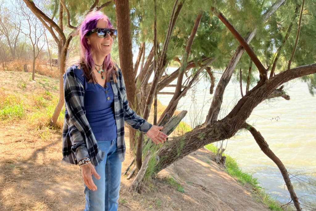 Elsa Hull stands along the Rio Grande in San Ygnacio, Texas, where Customs and Border Protection plans to install cylindrical border buoys. Credit: Martha Pskowski/Inside Climate News