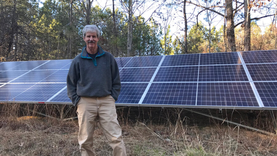 Mark Johnston, a plaintiff in the case, stands with the 6 kW solar array at his Alabama home. Credit: Courtesy of Southern Environmental Law Center