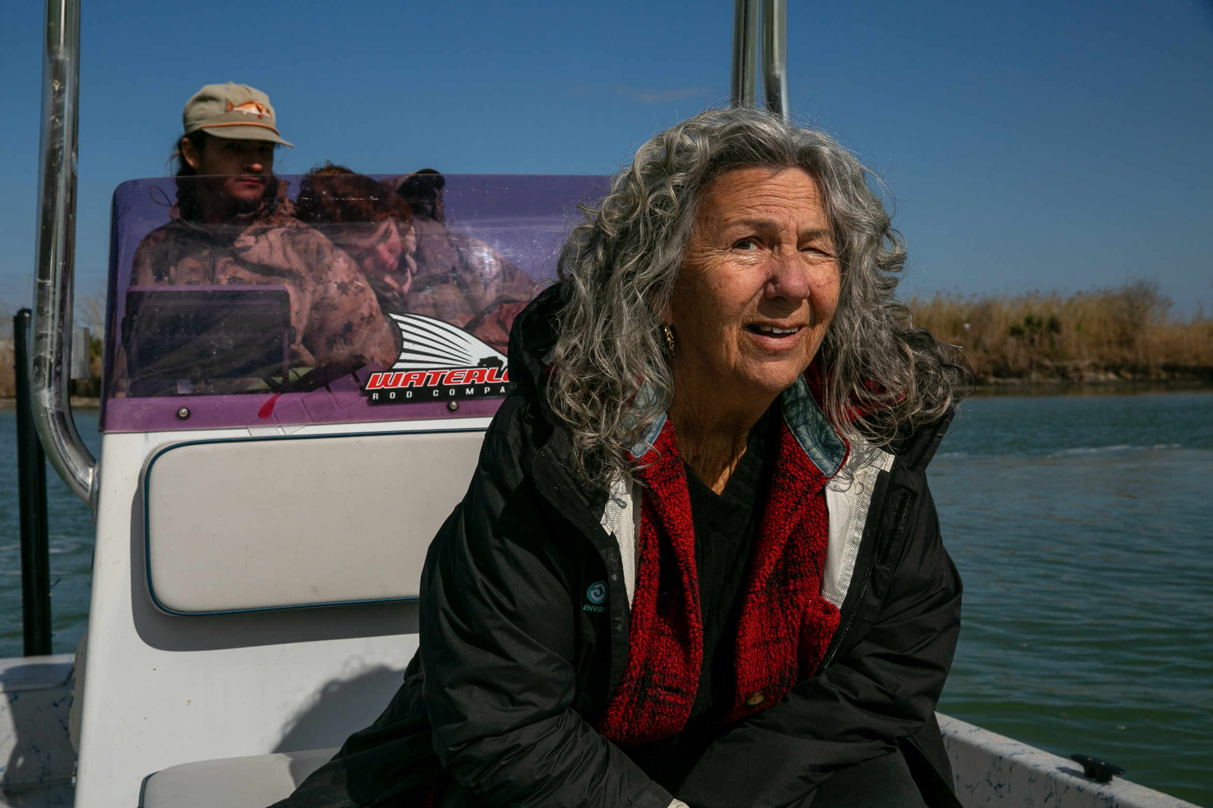 Diane Wilson, with her boat captain Rusty, searches for plastic pellets on the Victoria Barge Canal on Feb. 1.