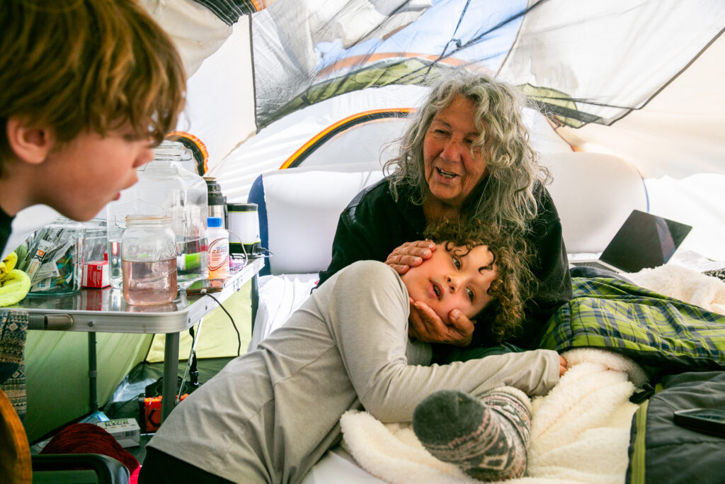 Diane Wilson receives a visit from her grandson and great-grandson at her tent outside Dow’s Seadrift complex on March 16.
