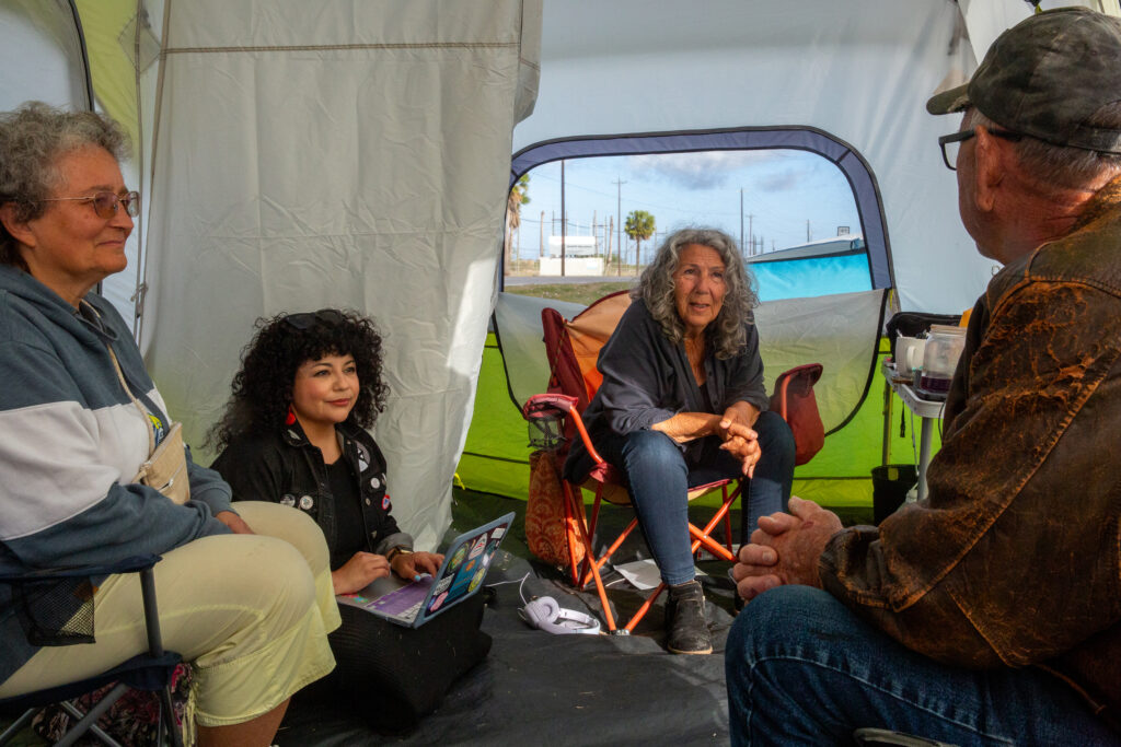 Diane Wilson speaks with friends and allies gathered in her tent on March 26.