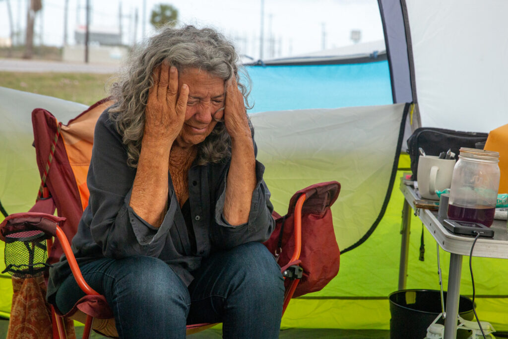 Diane Wilson winces to the sound of a train horn after 25 days on hunger strike on March 26.
