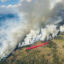 An air tanker works to slow the spread of the Dollar Lake Fire as it burns through Wyoming in August 2025. Credit: Kris Bruington/BLM