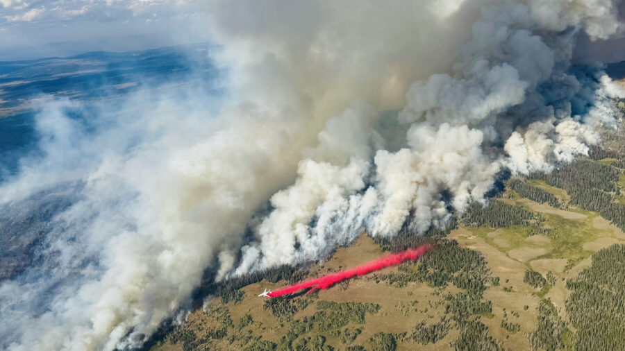 An air tanker works to slow the spread of the Dollar Lake Fire as it burns through Wyoming in August 2025. Credit: Kris Bruington/BLM