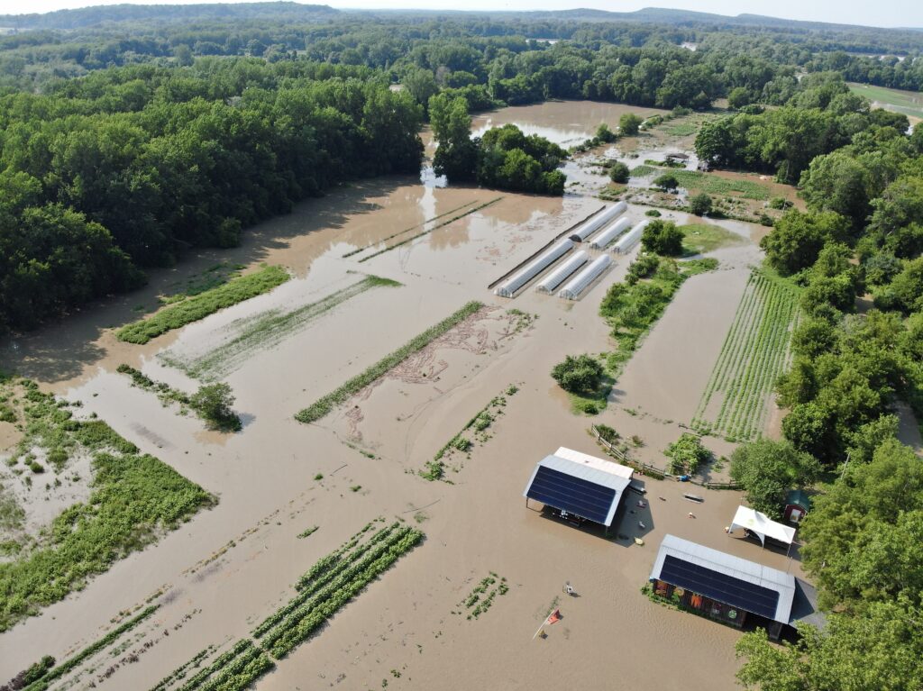 An aerial shot shows a flooded Intervale Community Farm in Burlington, Vt., in July 2023.
