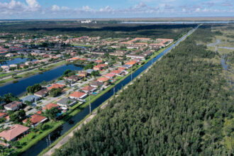 An aerial view of urban sprawl nestled next to protected wetlands on the fringes of Everglades National Park in Miami Dade County, Florida. Credit: Joe Raedle/Getty Images