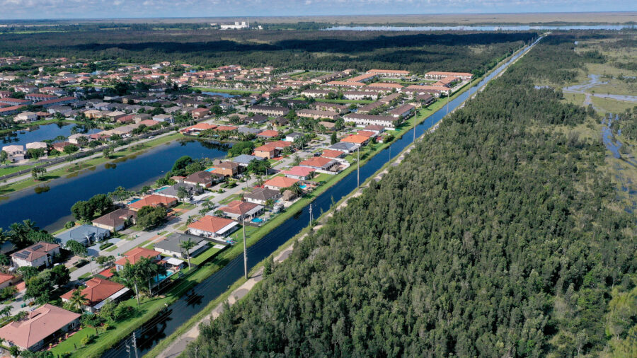 An aerial view of urban sprawl nestled next to protected wetlands on the fringes of Everglades National Park in Miami Dade County, Florida. Credit: Joe Raedle/Getty Images