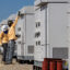 Technicians check equipment at a battery energy storage system in Daggett, Calif. Credit: Irfan Khan/Los Angeles Times via Getty Images