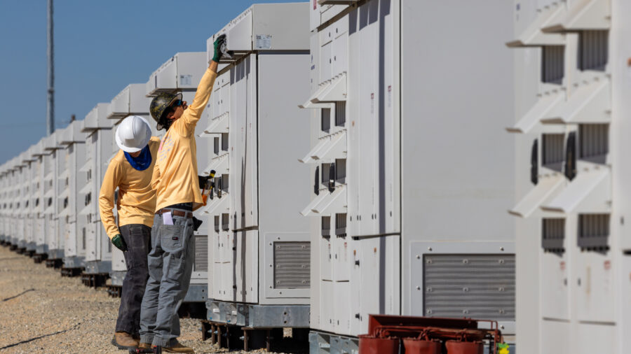 Technicians check equipment at a battery energy storage system in Daggett, Calif. Credit: Irfan Khan/Los Angeles Times via Getty Images