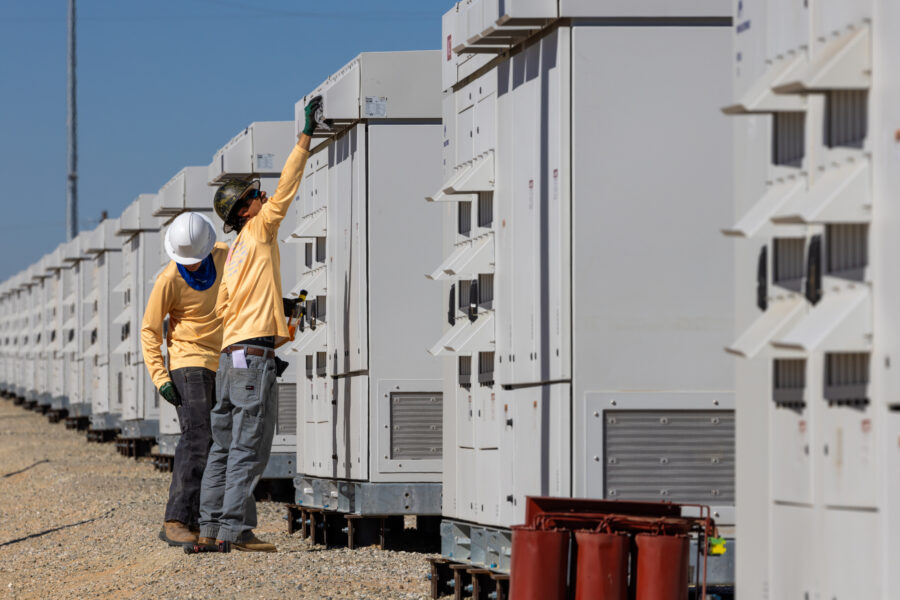 Technicians check equipment at a battery energy storage system in Daggett, Calif. Credit: Irfan Khan/Los Angeles Times via Getty Images