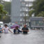 People walk through as flooded street as they evacuate during a storm on June 12, 2024, in Hollywood, Fla. Credit: Joe Raedle/Getty Images