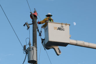 A utility worker with Florida Power & Light services a transformer in Punta Gorda, Fla., on Oct. 12, 2024. Credit: Thomas O'Neill/NurPhoto via Getty Images