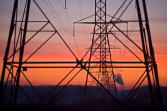 Transmission lines lead away from a coal-fired power plant in China Township, Mich. Credit: Jim West/UCG/Universal Images Group via Getty Images