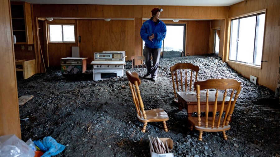 Misty Cheng looks at flood damage to her home in Wrightwood, Calif., on Dec. 25, 2025. Credit: Eric Thayer/Los Angeles Times via Getty Images