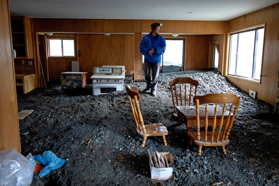 Misty Cheng looks at flood damage to her home in Wrightwood, Calif., on Dec. 25, 2025. Credit: Eric Thayer/Los Angeles Times via Getty Images