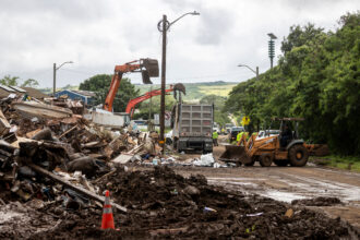 Excavators work to remove debris in Waialua, Hawaii, after a flood hit Oahu on March 23. Credit: Stephen Lam/San Francisco Chronicle via Getty Images