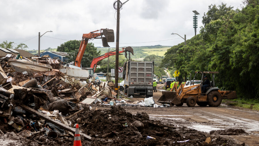 Excavators work to remove debris in Waialua, Hawaii, after a flood hit Oahu on March 23. Credit: Stephen Lam/San Francisco Chronicle via Getty Images