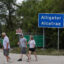 People walk near the front entrance to Alligator Alcatraz in the Florida Everglades on April 22. Credit: Joe Raedle/Getty Images