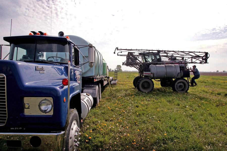A farmer loads herbicide into a sprayer to be applied to a corn field near Rochelle, Ill. Credit: Scott Olson/Getty Images