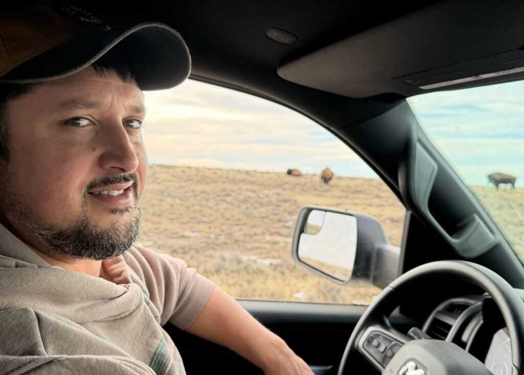 Scott Heidebrink, director of landscape stewardship for American Prairie, drives his truck around the foundation’s land. Credit: Blaine Harden/Inside Climate News