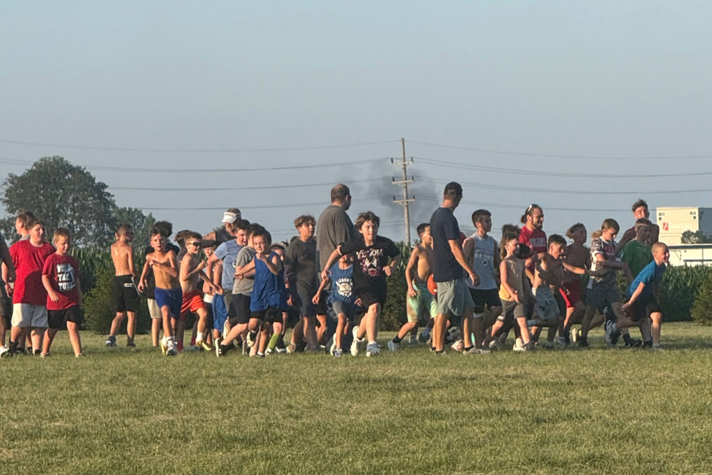 Children play in Hebron’s Evans Park with black smoke emitting from a nearby chemical recycling plant about a mile and a half away in July 2025. Credit: Courtesy of Shawn Jones