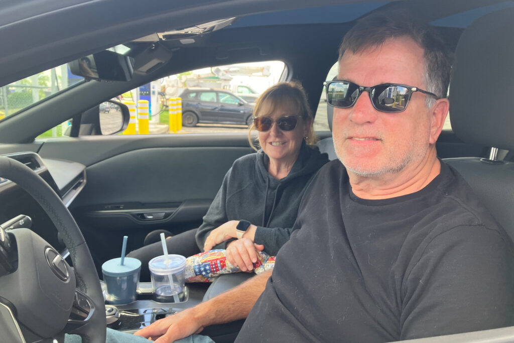 Cathy (left) and Chip Lillyman of Celina, Ohio, were charging their new Lexus EV this week at the TA Travel Center near London, Ohio. Credit: Dan Gearino/Inside Climate News