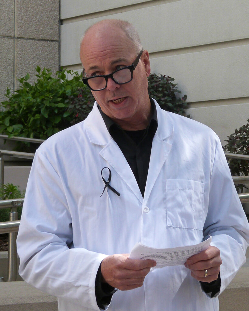 Greg Spooner, a physicist with Scientist Rebellion, offers a eulogy for the endangerment finding, repealed by the EPA. Credit: Liza Gross/Inside Climate News