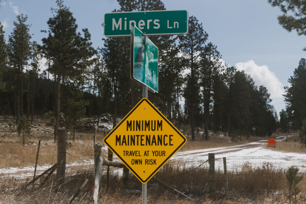 A road sign reading “Miners Ln” stands near a forest track in the Black Hills, close to a lithium exploration site. Credit: Carla Samon Ros/CJI