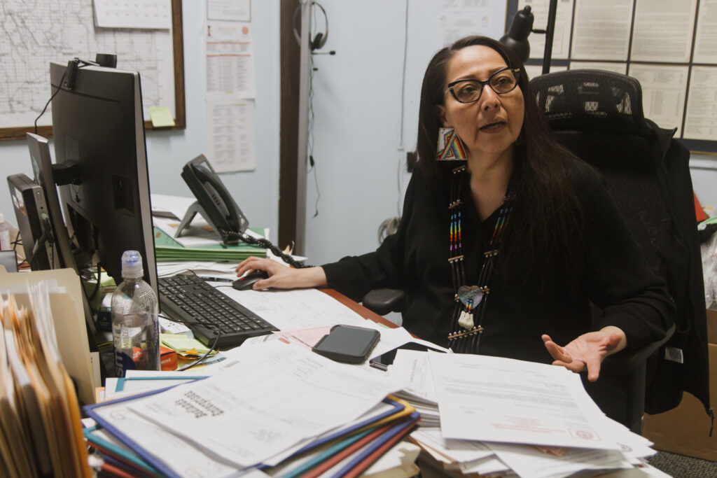 Trina Lone Hill, historic preservation officer for the Oglala Lakota, wears beaded earrings passed down from her great-great-grandmother, who fought at the Battle of Little Bighorn (Greasy Grass), where Lakota and allied tribes defeated U.S. Army forces in 1876. She brings her children to the site each year to mark the anniversary and teach them that their heritage is not only defined by loss. Credit: Carla Samon Ros/CJI