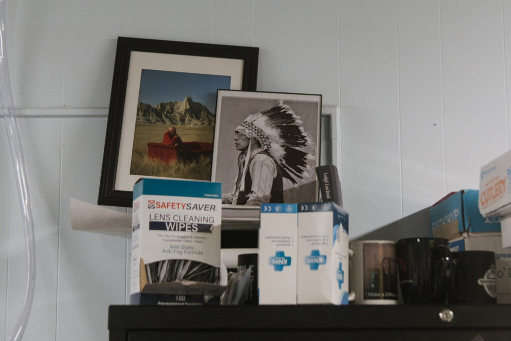 Framed photos in Trina Lone Hill’s office show her father, Mel Lone Hill, a former tribal vice-president and cultural leader, and her great-grandfather, Chief Frank Fools Crow, a prominent Lakota spiritual leader and fierce advocate for treaty rights. Credit: Carla Samon Ros/CJI