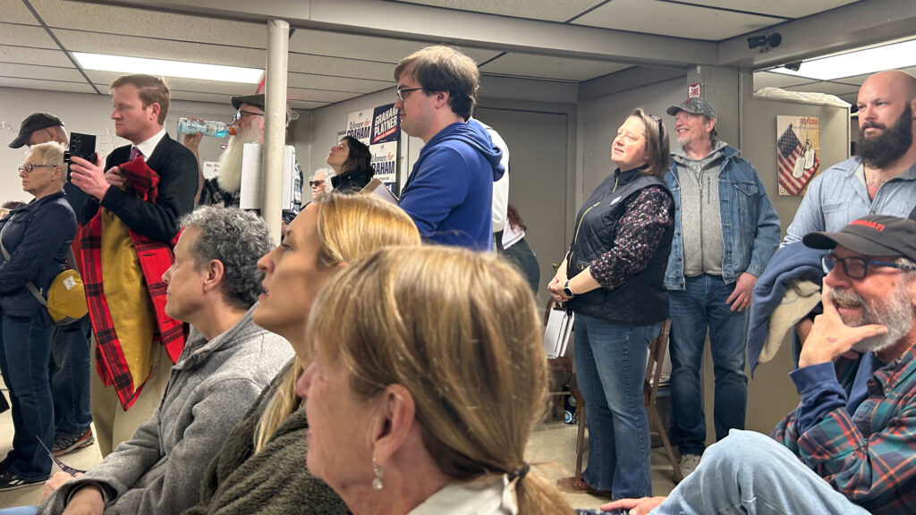 Attendees listen to Graham Platner speak at a campaign event in Sabattus, Maine. Credit: Nathaniel Eisen/Inside Climate News
