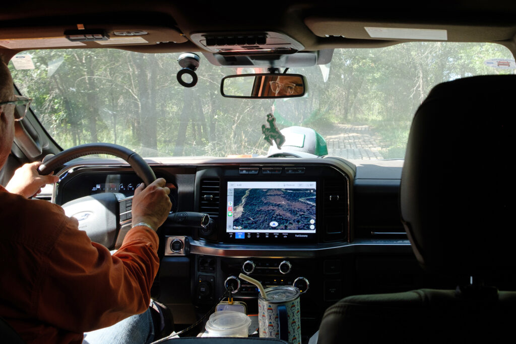 Curtis Shuck drives his truck to a well site in the Deep Fork National Wildlife Refuge.