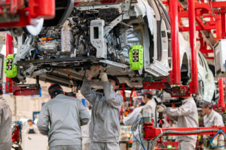 Workers assemble electric vehicles on Jan. 13 at a factory in Zhejiang, China. Credit: VCG via Getty Images