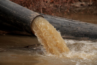 Pipes divert raw sewage into the C&O Canal around a broken section of the Potomac Interceptor on Feb. 16 in Cabin John, Md. Credit: Chip Somodevilla/Getty Images
