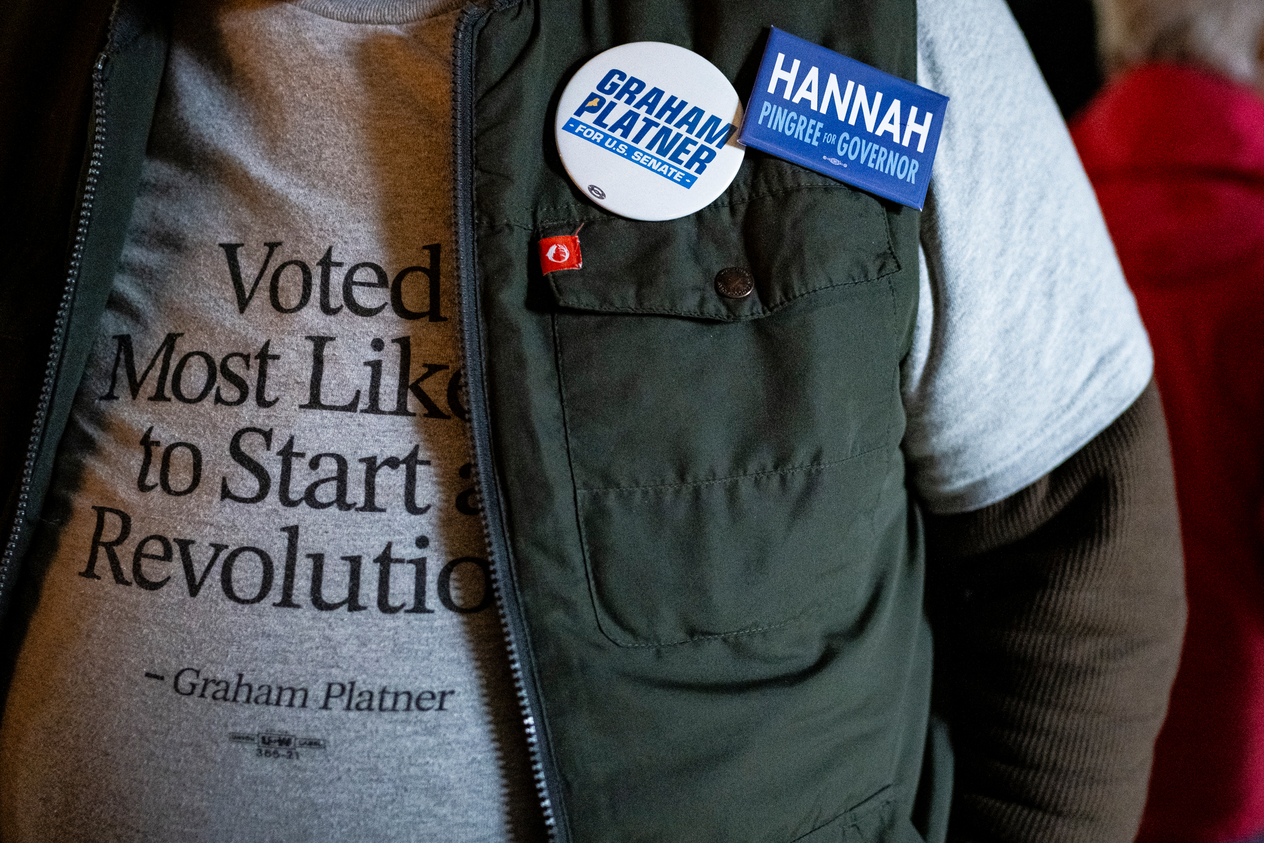 An attendee wears campaign materials during a Graham Platner for Senate townhall event on May 2 in Appleton, Maine. Credit: Graeme Sloan/Getty Images