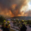 Firefighters monitor the Sandy Fire as it burns close to a residential area on Monday in Simi Valley, Calif. Credit: Apu Gomes/AFP via Getty Images