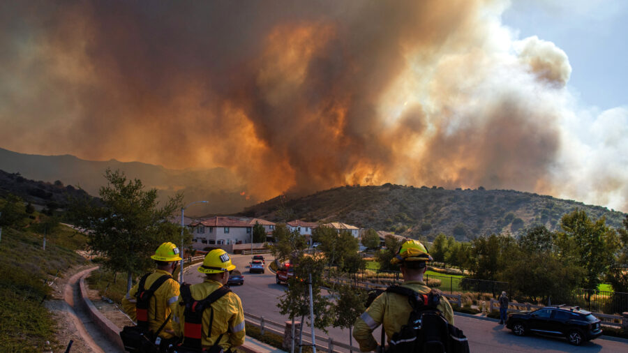 Firefighters monitor the Sandy Fire as it burns close to a residential area on Monday in Simi Valley, Calif. Credit: Apu Gomes/AFP via Getty Images