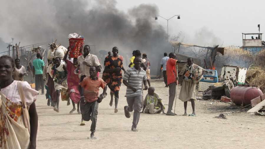 People flee a U.N. base, where gunmen opened fire on South Sudanese civilians sheltering inside, in the town of Malakal on Feb. 18, 2016. Scientists tracing links between climate impacts and conflicts found that some regions can tip toward violence when they reach extreme drought tipping points. Credit: Justin Lynch/AFP via Getty Images